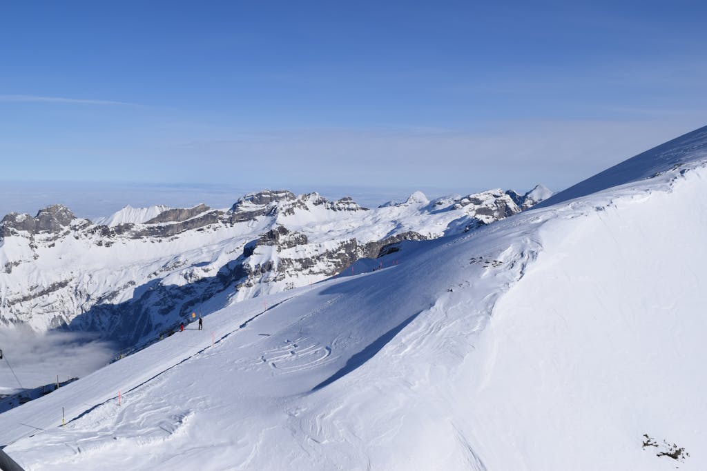 Breathtaking view of snow-covered ski slopes and mountains in Engelberg, Switzerland.